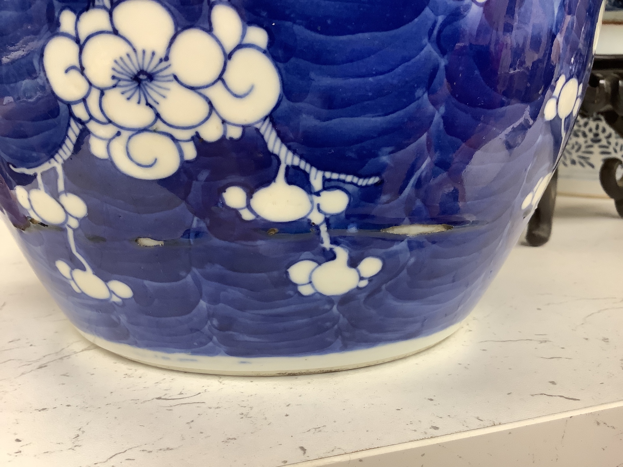 A 19th century Chinese porcelain prunus jar and cover, 27cm, on carved wood stand, a smaller famille noire jar and cover, a Chinese export fruit bowl, blue and white dish and a similar jar and cover 27cm
